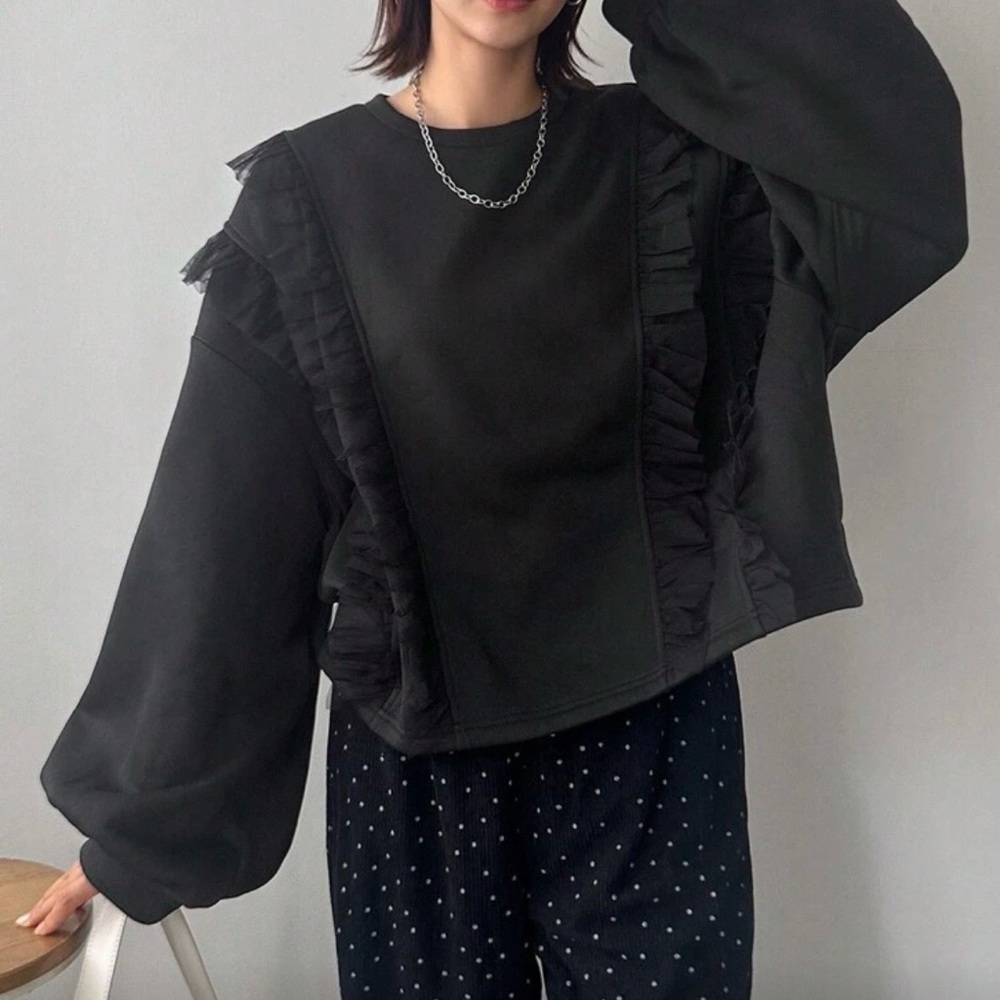 Black cropped sweatshirt with lace ruffle detail.